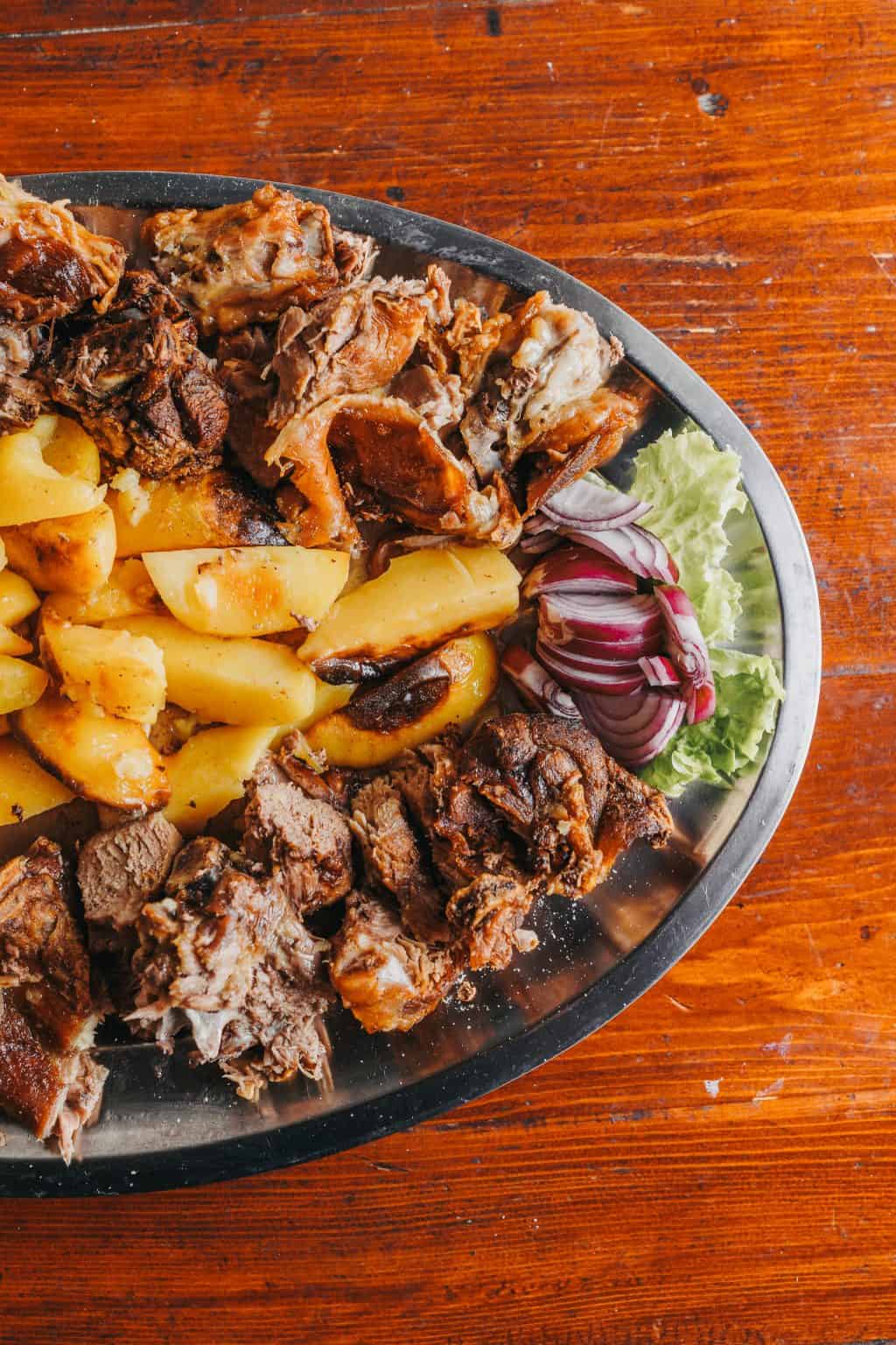 Fresh peka cooked over open flame in traditional style, ready for guests at Dubrovnik local food spot